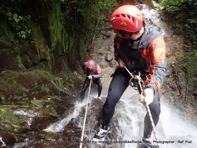 canopying rapelling down a waterfall in banos on a motorcycle tour in ecuador