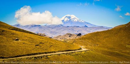 dirt road leading towards Chimborazo in the background with motorcycles