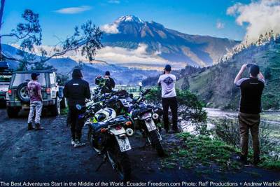 adventure motorcyclists and a jeep stop to view a mountain and the amazon basin in Ecuador