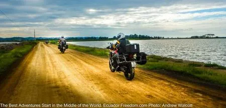 motorcycles on a causeway between shrimp farms on the coast of ecuador