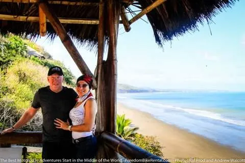 couple on motorcycle tour at beach in ecuador south america