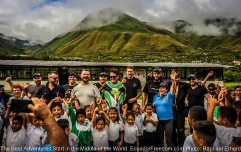 motorcycle tour group at a school visit pack for a purpose ecuador