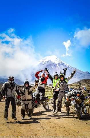 motorcyclists jumping for joy on a motorcycle tour in ecuador